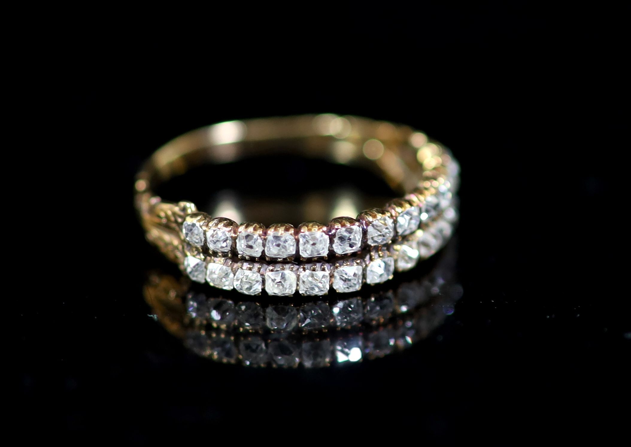 A 19th century gold and twin row old mine cut diamond set half hoop ring